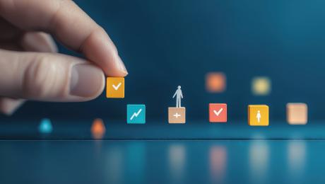 Man's hand placing colorful blocks representing tasks and peopl.