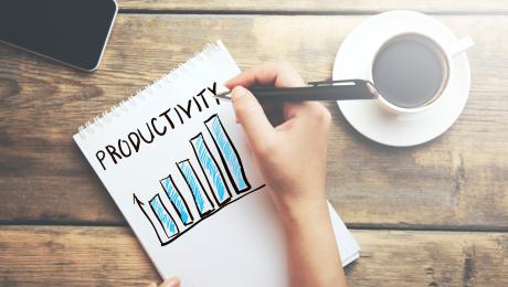 Woman's hand drawing a software productivity bar chart.